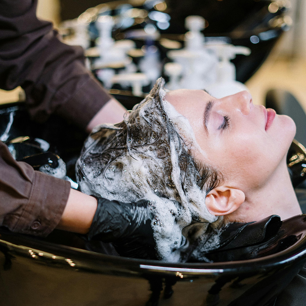 woman at a salon getting hair washed