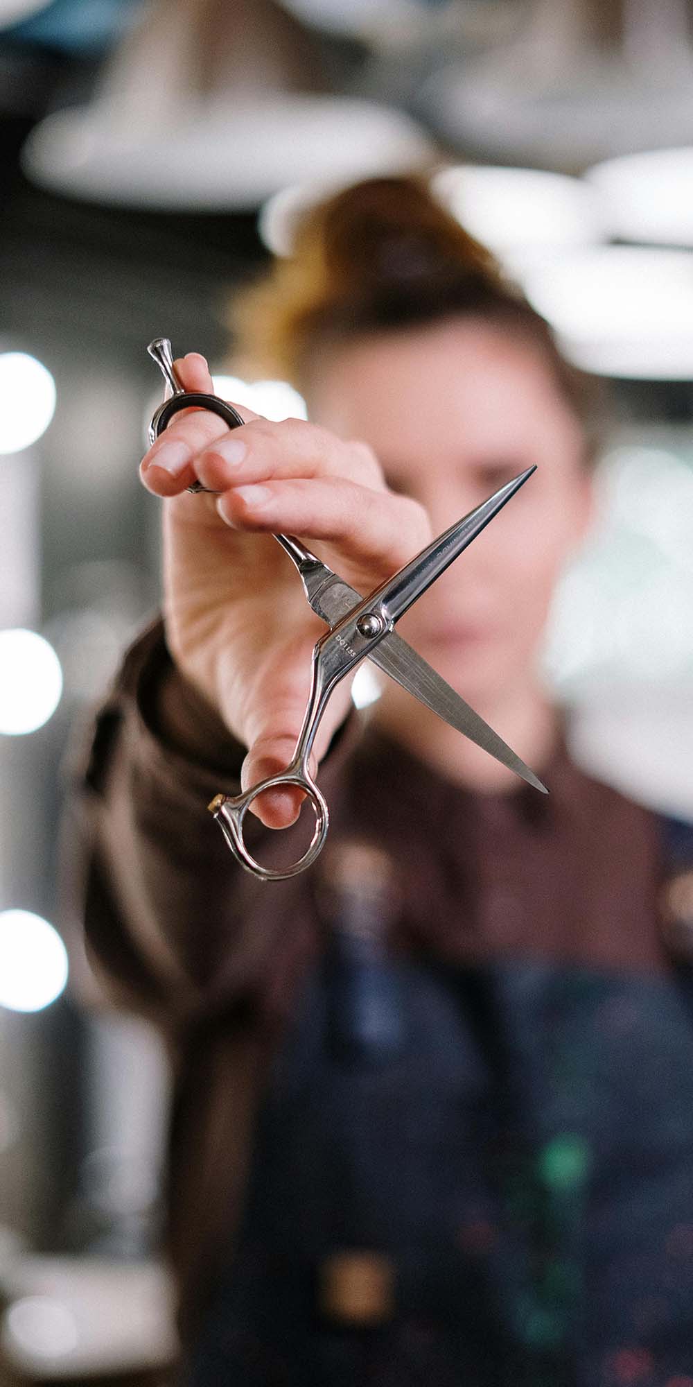 Hair stylist holding up scissors